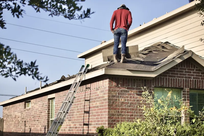 Professional roofer working on a residential roof in Dampman